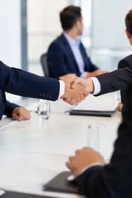 Business Professionals Handshake in Modern Meeting
