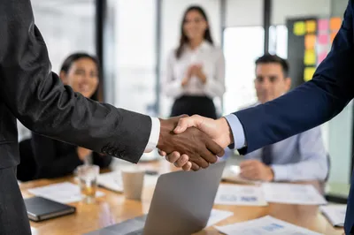 Professional Handshake in Modern Business Meeting