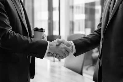 Professional Handshake in Modern Office Meeting