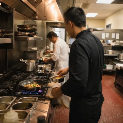Chefs Preparing Food in Busy Kitchen