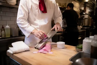 Restaurant Chef Slicing Radish in Kitchen