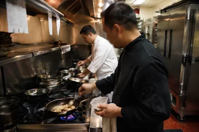 Chefs Preparing Food in Busy Kitchen