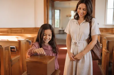 Child Donating Coin in Sunlit Church