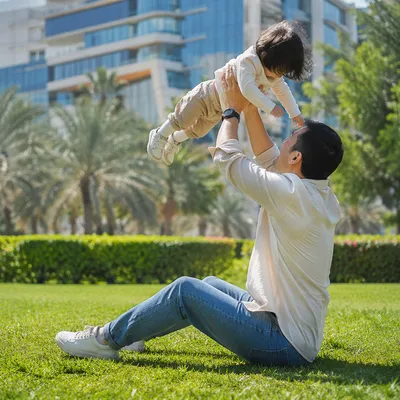 Joyful Parent and Toddler Playing in Park