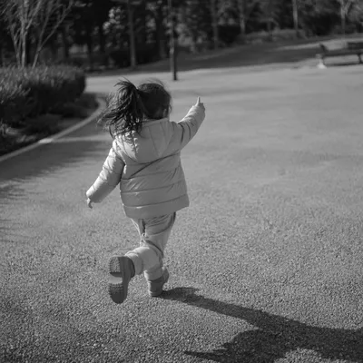 Joyful Child Running Through Quiet Park