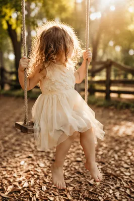 Happy Child on Sunlit Park Swing