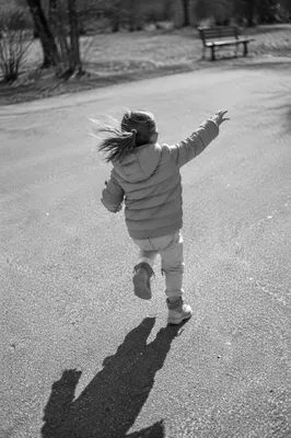 Joyful Child Running Through Winter Park