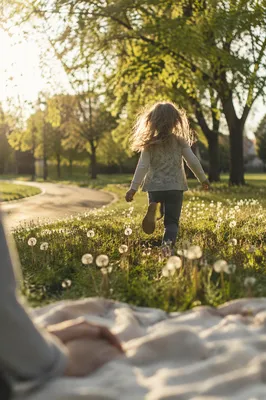 Happy Child Running Through Sunlit Park