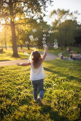Happy Child Running Through Sunny Park