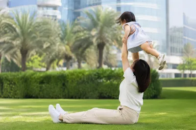 Happy Parent and Toddler Playing in Park