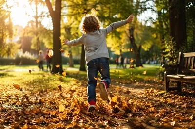 Joyful Child Running Through Autumn Park