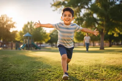 Happy Boy Running in Neighborhood Park