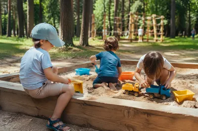 Happy Children Playing in Forest Park Sandbox