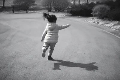 Joyful Child Running Through Quiet Park