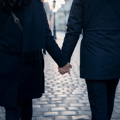 Romantic Couple Holding Hands on Cobblestones