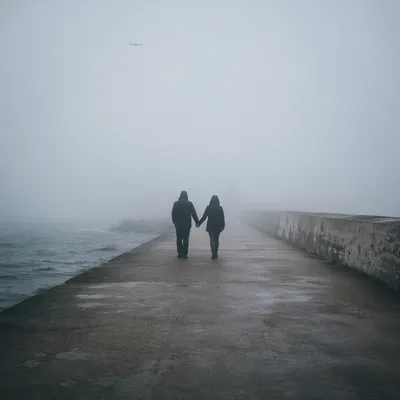 Couple Walking Hand in Hand in Fog