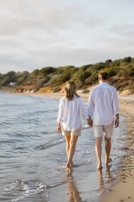 Romantic Couple Walking Hand in Hand on Beach