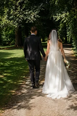 Newlywed Couple Walking Through Leafy Park