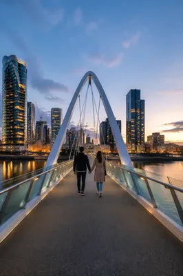 Romantic Couple Walking Across Blue Hour Bridge