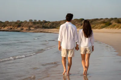 Romantic Couple Walking Hand in Hand on Beach