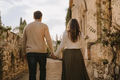 Romantic Couple Walking Beside Chapel Wall