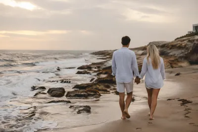 Romantic Couple Walking Along Rocky Shoreline