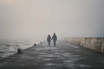Foggy Seaside Walk of Devoted Couple