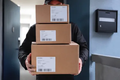 Delivery Driver Carrying Packages to Doorstep