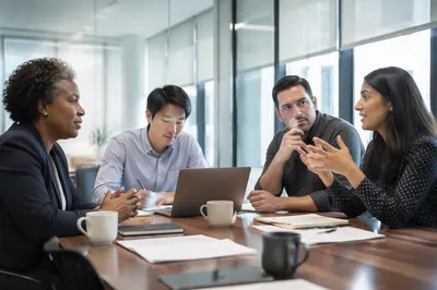 Diverse Team Meeting in Glass Conference Room