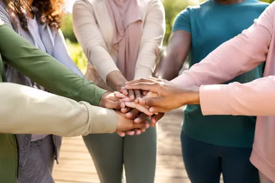Multicultural Team Hands Stacked in Unity