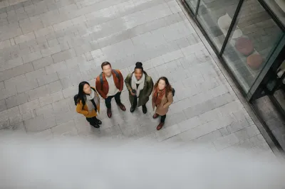 Multicultural Friends Looking Up in Urban Courtyard