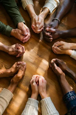 Diverse Hands Joined in Prayer Circle