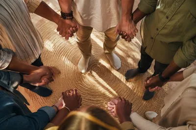 Diverse Prayer Circle Hands in Morning Light