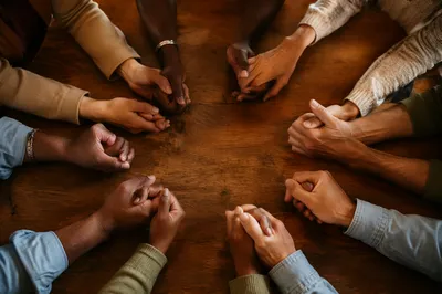 Diverse Hands Joined in Prayer Circle