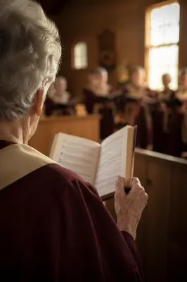 Elderly Choir Member Holding Hymnal on Sunday