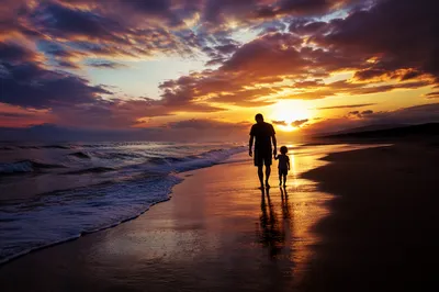 Family Silhouettes Walking on Beach at Sunset