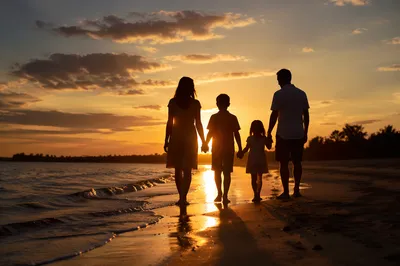 Family Walking on Beach at Sunset