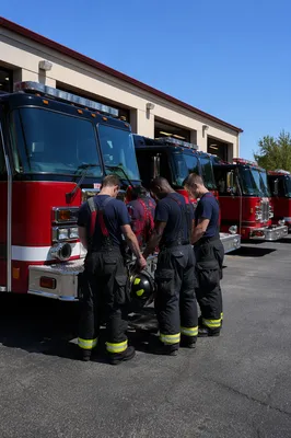 Firefighters Praying Outside Fire Station