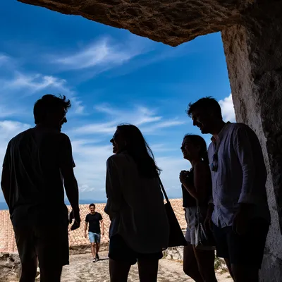 Joyful Friends Laughing Under Stone Overhang