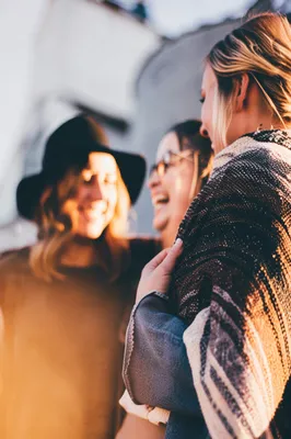 Friends Laughing Outdoors in Autumn Sunlight
