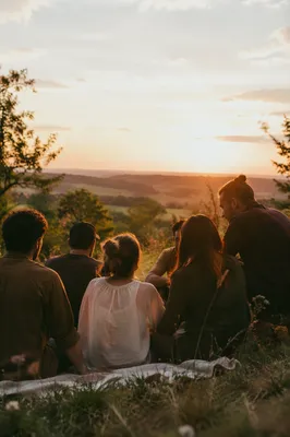 Friends Laughing on a Golden Hillside