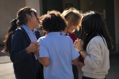 Joyful School Friends Laughing in Courtyard