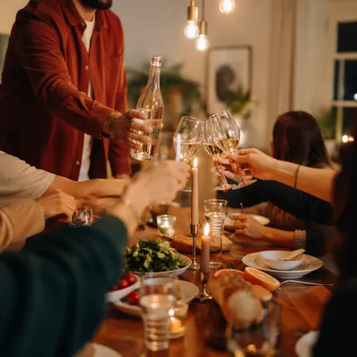 Friends Laughing at Warm Dinner Celebration