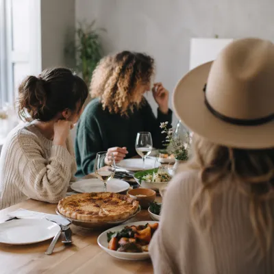 Friends Laughing Around Cozy Dinner Table