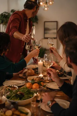 Friends Toasting at Cozy Dinner Celebration