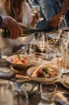 Friends Celebrating at Warm Dinner Table