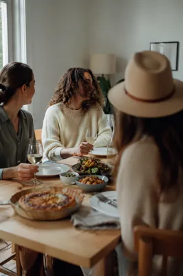 Friends Laughing Around Cozy Dinner Table