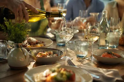 Friends Celebrating Around a Sunlit Dinner Table