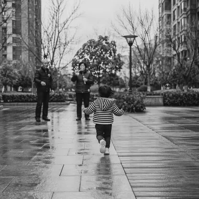 Grandparents and Grandchild Playing in Courtyard