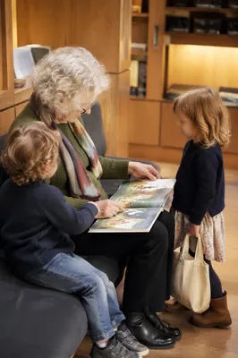 Grandmother Reading With Grandchildren in Library